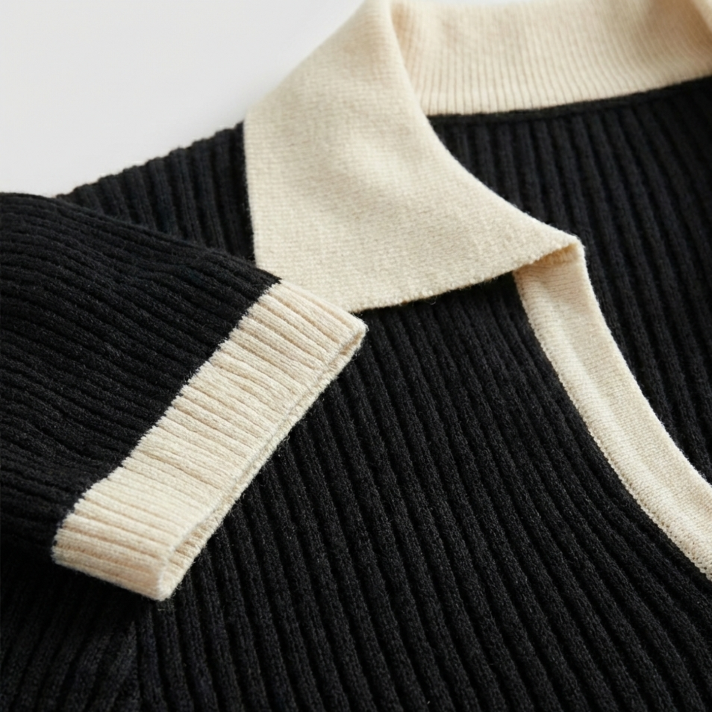 Ribbed knit long-sleeve top featuring a contrasting cream-colored spread collar and matching cream cuffs.