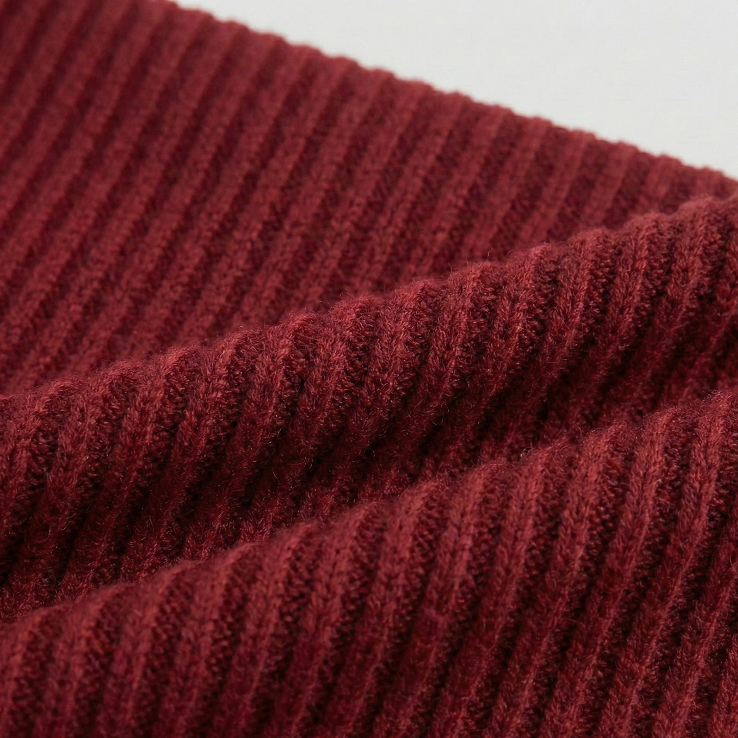 Ribbed knit long-sleeved top featuring an off-the-shoulder fold-over neckline and a cropped fit.