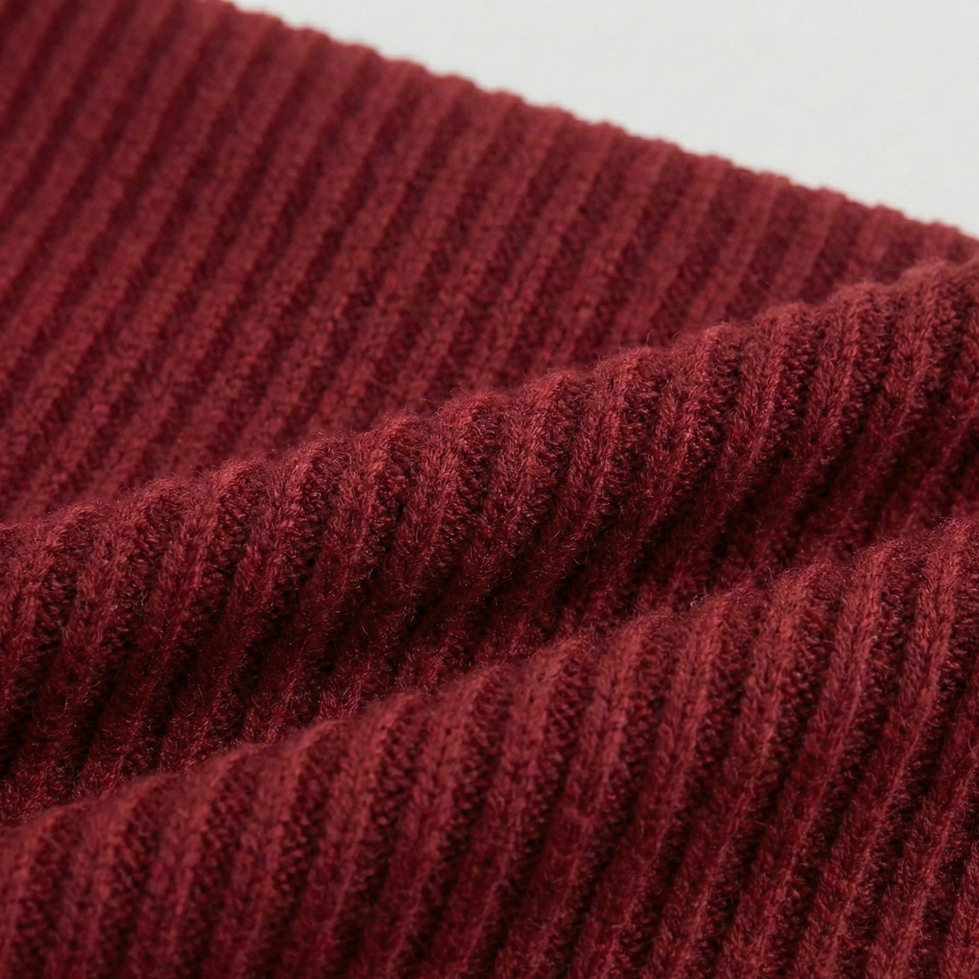 Ribbed knit long-sleeved top featuring an off-the-shoulder fold-over neckline and a cropped fit.