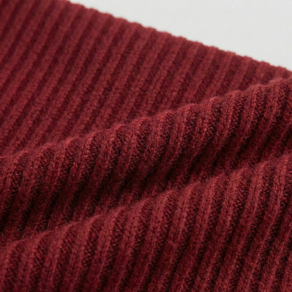 Ribbed knit long-sleeved top featuring an off-the-shoulder fold-over neckline and a cropped fit.