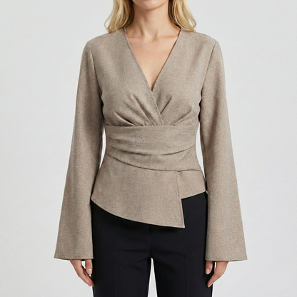 Tailored wrap-style blouse with a V-neckline and long bell sleeves, featuring a pleated waist detail and asymmetrical hem.