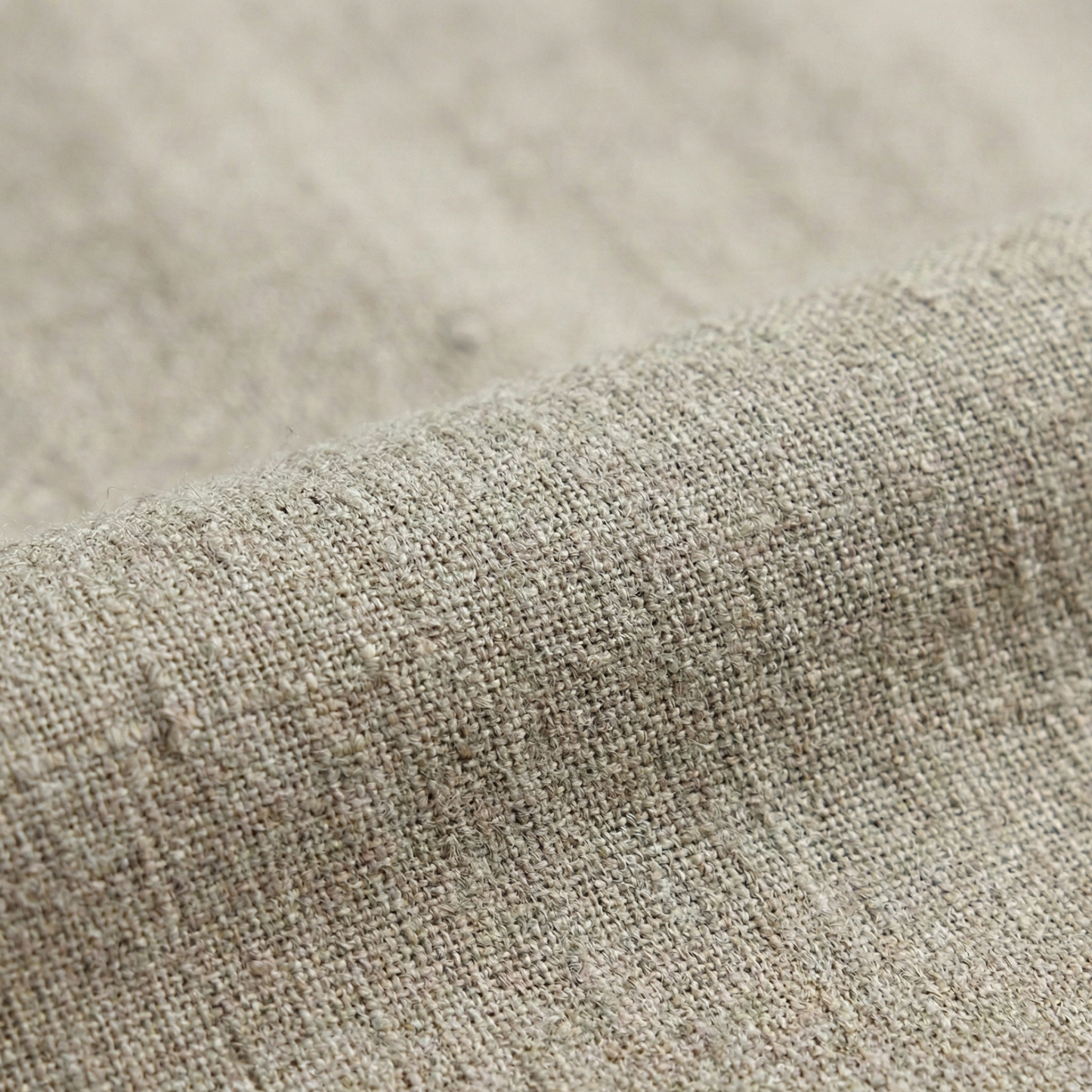 Tailored wrap-style blouse with a V-neckline and long bell sleeves, featuring a pleated waist detail and asymmetrical hem.