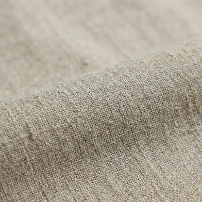 Tailored wrap-style blouse with a V-neckline and long bell sleeves, featuring a pleated waist detail and asymmetrical hem.