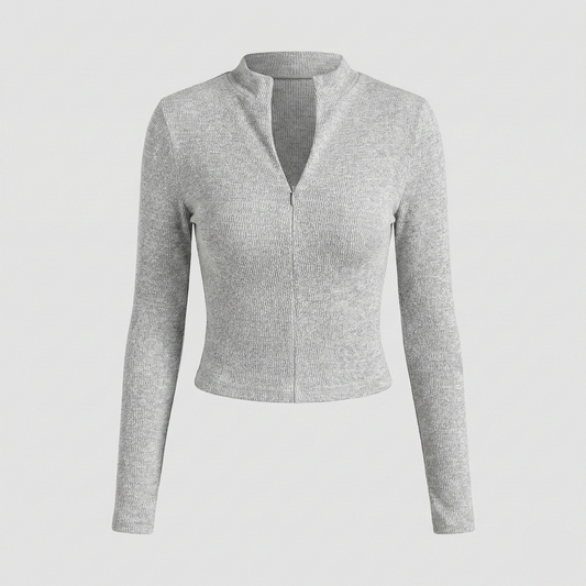 Textured knit top with a mock neckline and front zipper, featuring long sleeves and a form-fitting silhouette.