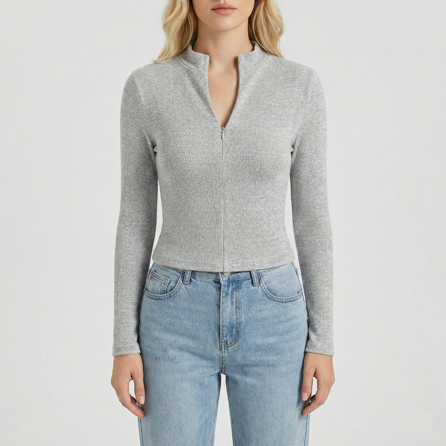 Textured knit top with a mock neckline and front zipper, featuring long sleeves and a form-fitting silhouette.