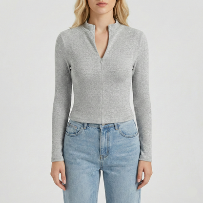 Textured knit top with a mock neckline and front zipper, featuring long sleeves and a form-fitting silhouette.